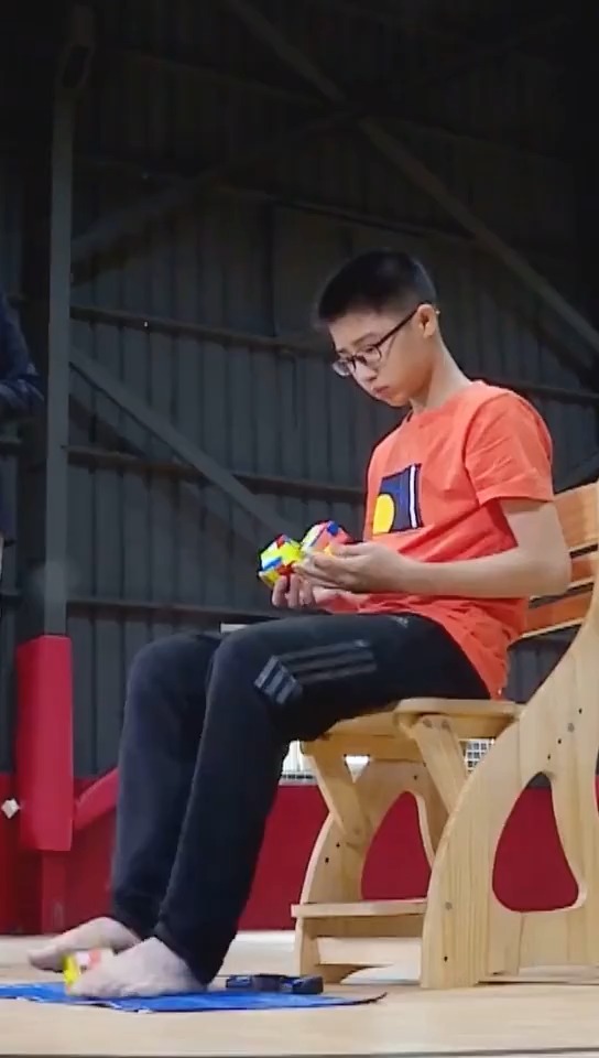 厦门13岁少年阙剑宇手脚同时解三个魔方用时1分36.39秒.