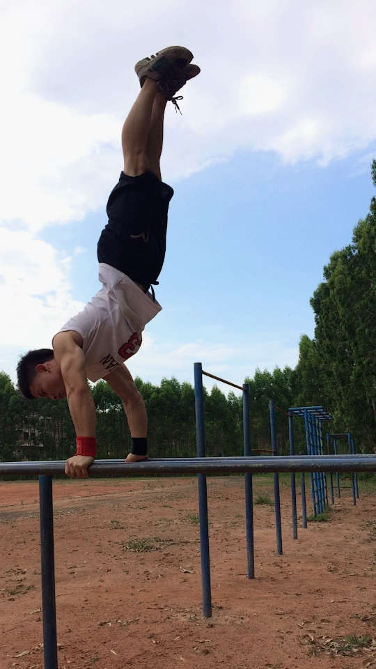 蓝天下双杠踩步的街健少年.